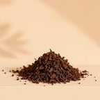 Heap of dark brown Incense blend on a beige background
